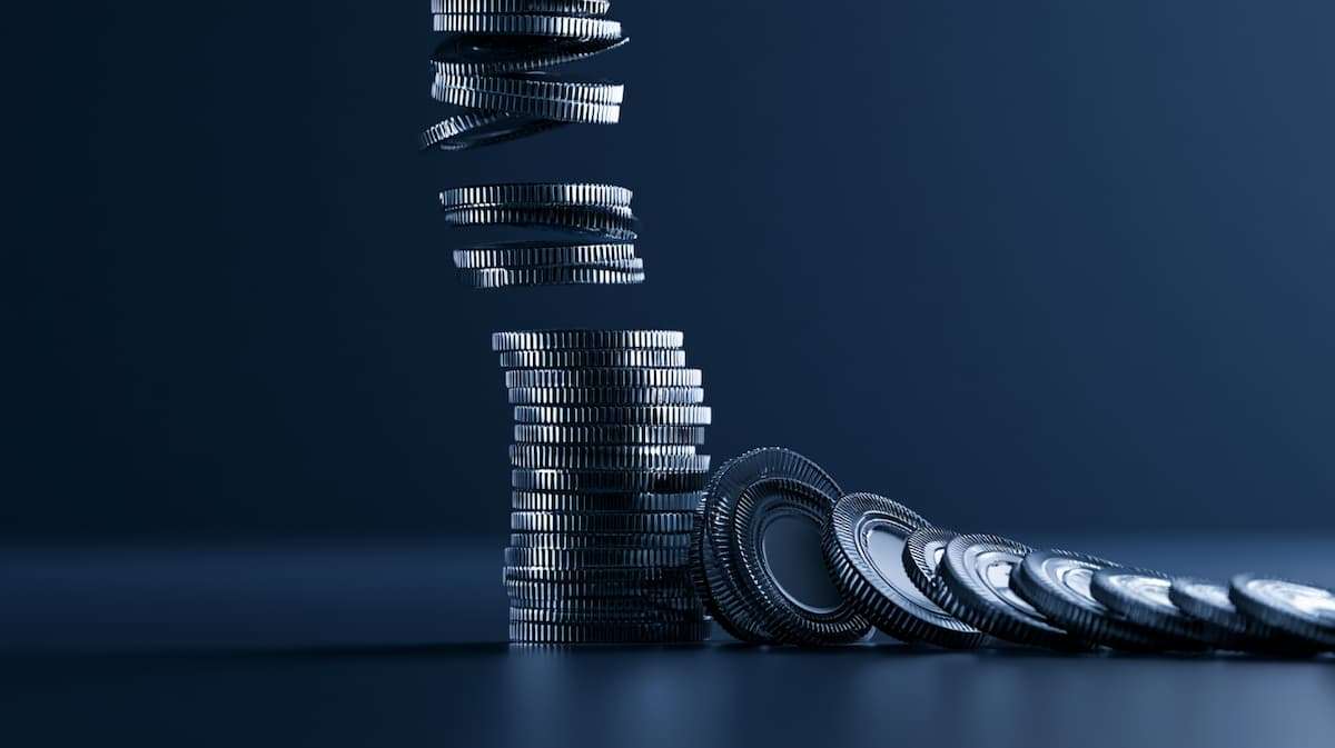 Stacked coins representing ecommerce tariff cost absorption, margin compression, and declining profitability