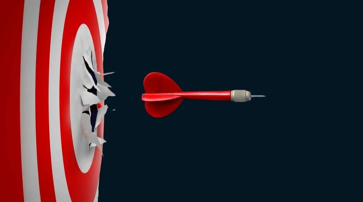 Red dart striking the bullseye of a target, representing budget sandbagging, conservative forecasting, and distorted financial targets that drive poor capital allocation.